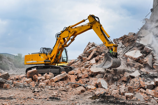 Excavator working through rubble pile