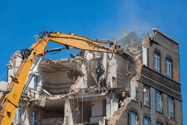 Large demolition excavator working on a building